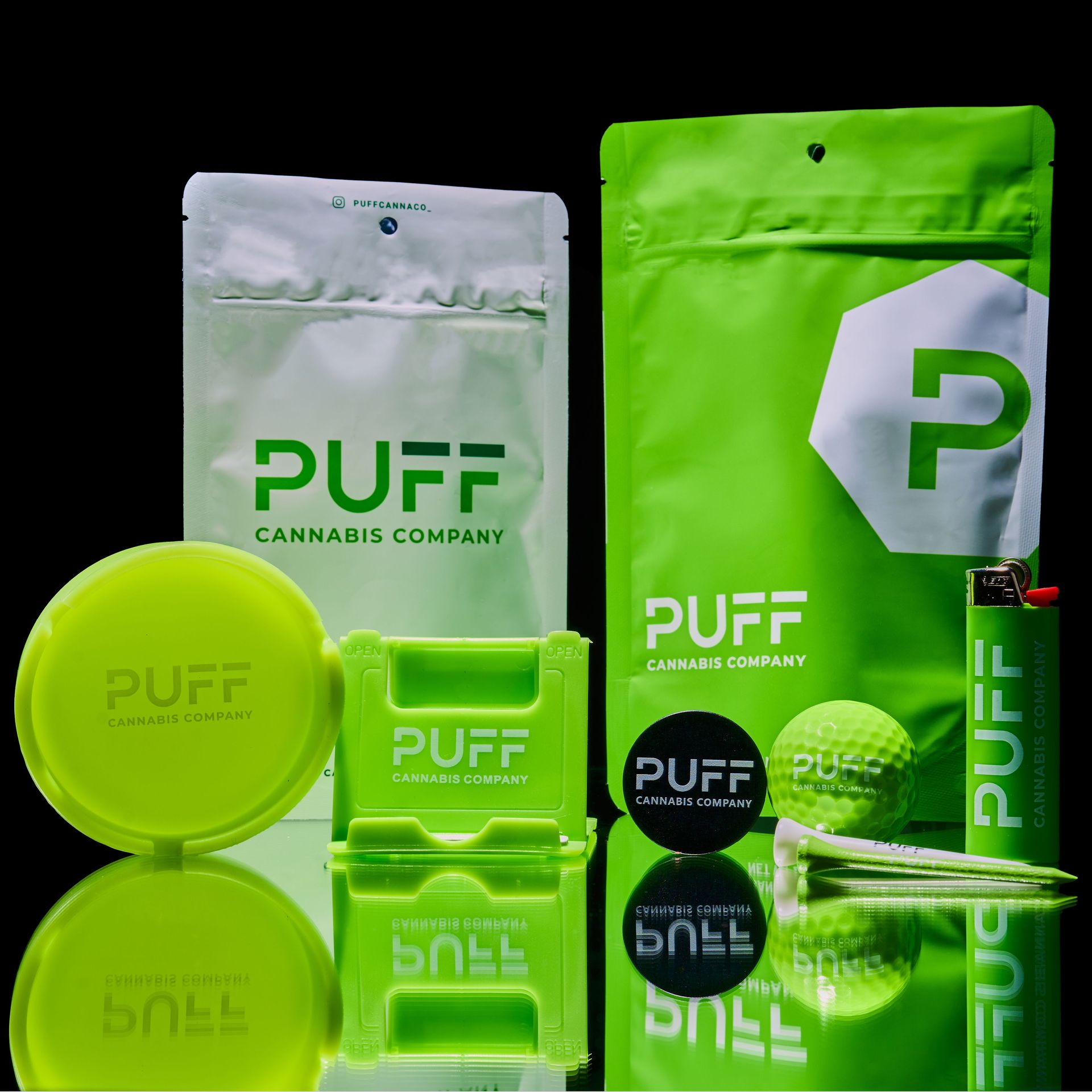 Puff cannabis branded items. Mylar bags, ashtray, phone stand, golf balls, lighter, and phone stand
